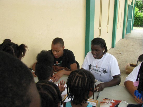Christine Williamson and Charmaine Clark sign autographs for local youth