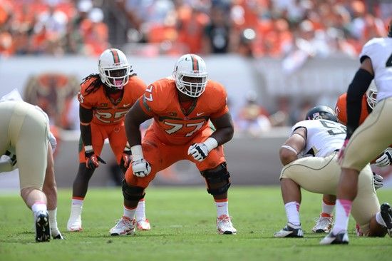 University of Miami Hurricanes offensive lineman Seantrel Henderson #77 gets set to block against the Wake Forest Demon Deacons at Sun Life Stadium on...
