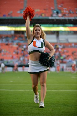 A University of Miami cheerleader shows her team spirit in a game against the Virginia Cavaliers at Sun Life Stadium on November 23, 2013.  Photo by...