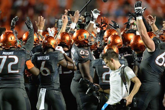 University of Miami Hurricane players meet at the 50 yard line in a sign of unity before a game against the Florida State Seminoles at Sun Life...