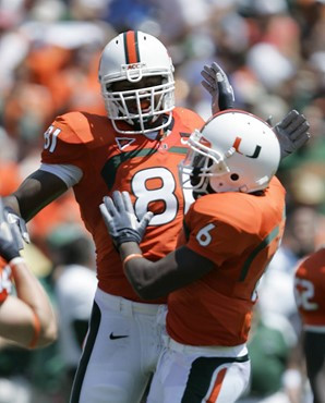 Miami defensive end Calais Campbell (81) celebrates with cornerback Randy Phillips after a tackle by Campbell during the first quarter of a football...