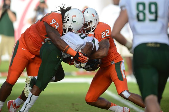 University of Miami Hurricanes Kacy Rodgers #22 And defensive lineman Luther Robinson #93 plays in a game against the University of South Florida...