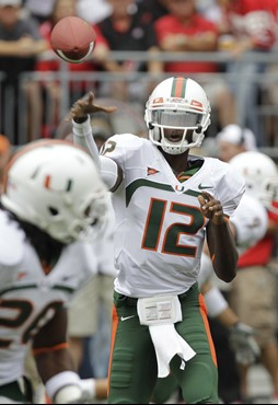 Miami  quarterback Jacory Harris (12) lofts a pass to running back Damien Berry during the first quarter of an NCAA college football game against Ohio...