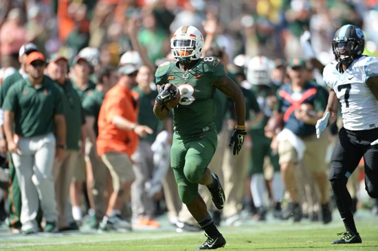 University of Miami Hurricanes running back Duke Johnson #8 scores a touchdown in a game against the North Carolina Tar Heels at Sun Life Stadium on...