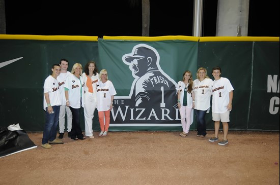 Ron Fraser's family poses with the new outfield wall banner commemorating the 