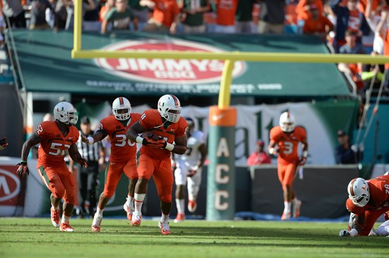 Defensive lineman David Gilbert #11 and The University of Miami Hurricanes plays in a game against the Virginia Cavaliers at Sun Life Stadium on...