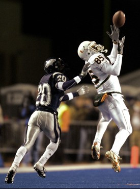 Miami wide receiver Ryan Moore hauls in a long pass against Nevada defensive back Devan Walker during the second quarter of the MPC Computers Bowl....