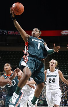 Miami's Riquna Williams (1) puts up a layup in front of Michigan State's Courtney Schiffauer (24) during the first half. (AP Photo/Al Goldis)
