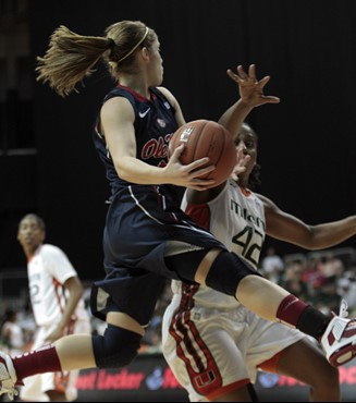 Ole Miss' Maggie McFerrin (14) prepares to pass over Miami's guard Shenise Johnson (42) in the second half. (AP Photo/Alan Diaz)