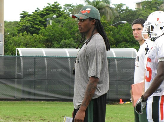 Senior Travis Benjamin, trading in his pads for a whistle on day six, helps coach his fellow receivers during a drill.