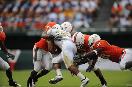 University of Miami Hurricanes linebacker Sean Spence #31 dives for a tackle in a game against the University of Central Florida Knights at Dolphin...