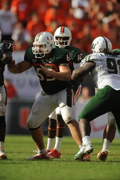 University of Miami Hurricanes offensive lineman Tyler Horn #63 plays in a game against the University of South Florida Bulls at Sun Life Stadium on...