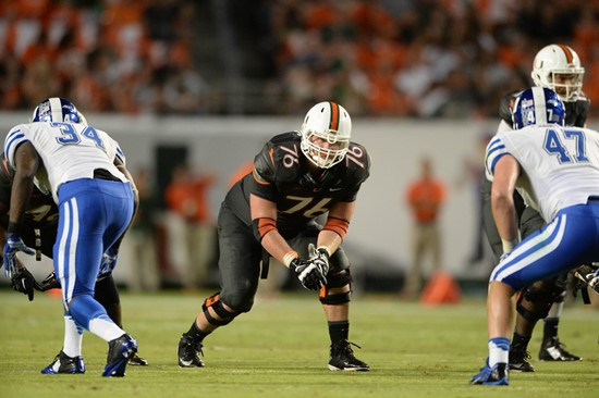 University of Miami Hurricanes offensive lineman Taylor Gadbois #76 gets set to rush in a game against the Duke Blue Devils at Sun Life Stadium on...