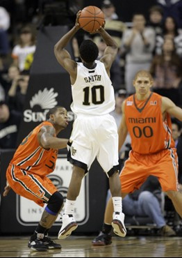 Wake Forest's Ishmael Smith (10) shoots the game-winning basket as Miami players Jack McClinton (33) and Jimmy Graham (00) looks on during the second...