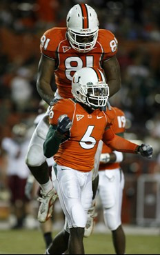 Miami's Randy Phillips (6) celebrates as teammate Calais Campbell (81) jumps on his back after breaking-up a play against Boston College during the...