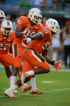 University of Miami Hurricanes linebacker Jimmy Gaines #59 plays in a game against the University of South Florida Bulls at Sun Life Stadium on...