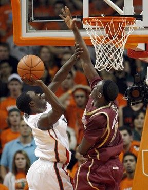 Boston College's Reggie Jackson, right, prepares to block a shot by Miami's  Durand Scott in the second half of a NCAA  college basketball game in...