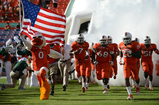 Sebastian the Ibis leads the University of Miami Hurricanes through a tunnel of smoke in a game against the University of South Florida Bulls at Sun...