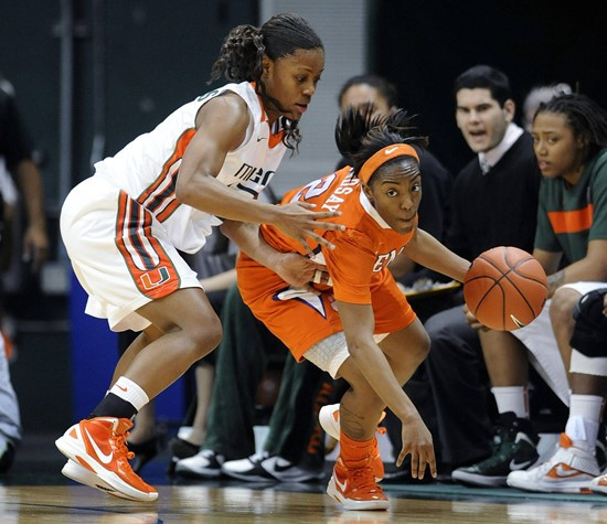 Miami's Suriya McGuire, left, defends Clemson's Chelsea Lindsay, right, during the first half of an NCAA college basketball game Sunday, Feb. 5, 2012,...