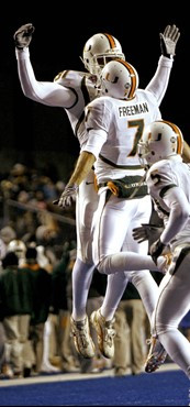 Miami quarterback Kirby Freeman celebrates with defensive end Calais Campbell after Freeman scored a touchdown against Nevada during the first quarter...