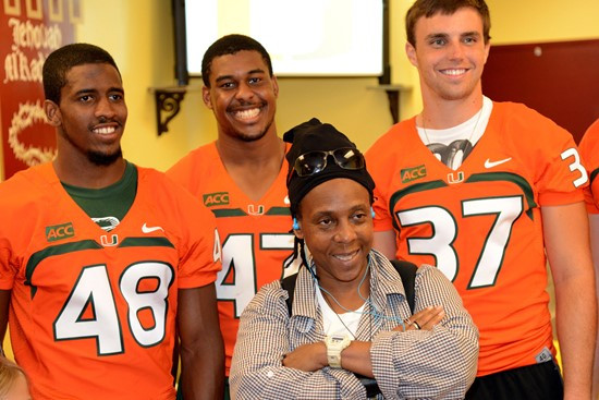 Hugo Delapenha, Akil Craig and Alex Irastorza with a Canes fan