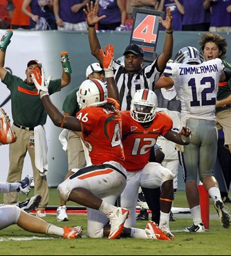 Miami quarterback Jacory Harris (12) gets up next to Clive Walford (46) after a touchdown attempt that was overturned in the final minute of an NCAA...