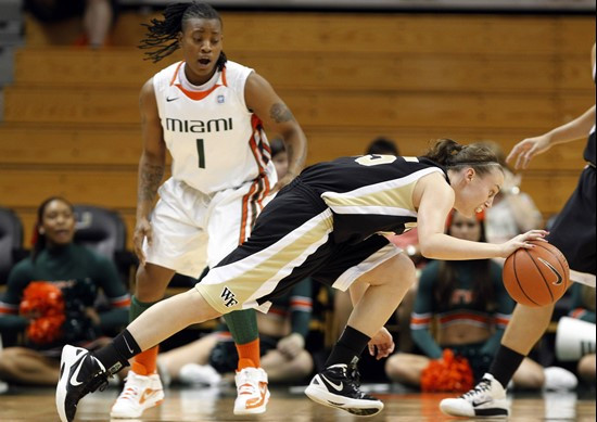 Wake Forest's Millesa Calicott, front, drives to the basket as Miami's Riquna Williams. (AP Photo/Lynne Sladky)