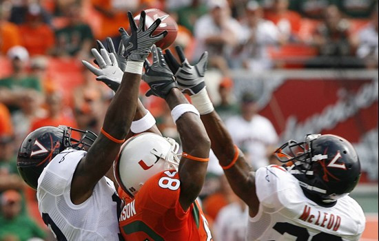 Virginia's Ras-I Dowling, leftm, and teammate Rodney McLeod (28) tip a pass intended for Miami's Leonard Hankerson (85) during the second quarter of...