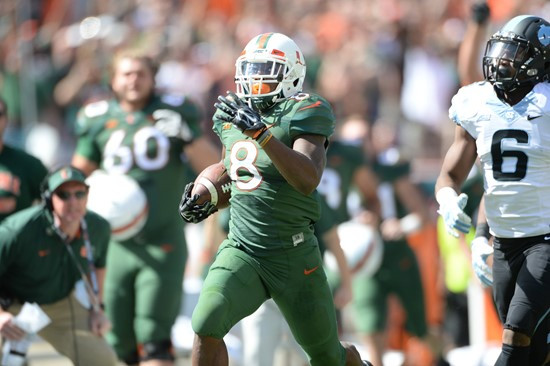 University of Miami Hurricanes running back Duke Johnson #8 scores a touchdown in a game against the North Carolina Tar Heels at Sun Life Stadium on...