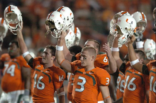 University of Miami players salute the crowd with their helmets before a game against the Virginia Cavaliers at the Orange Bowl on November 10, 2007. ...