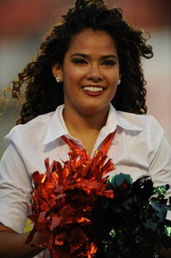 A University of Miami Hurricane cheerleader shows her team spirit in a game against the Boston College Eagles at Sun Life Stadium on November 25,...