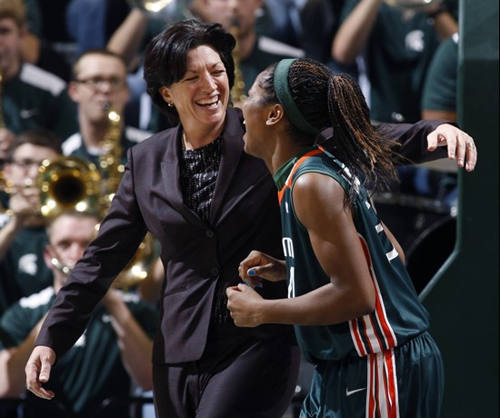 Miami coach Katie Meier, left, celebrates with Sylvia Bullock following a 76-60 win over Michigan State. (AP Photo/Al Goldis)