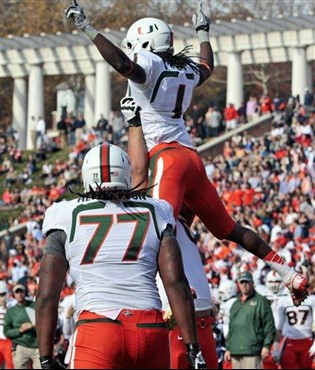 Miami wide receiver Allen Hurns (1) celebrates a touchdown with teammates including offensive linesman Seantrel Henderson (77) during an NCAA college...