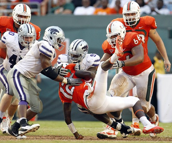 Miami quarterback Jacory Harris (12) is upended by Kansas State defensive end Adam Davis in the fourth quarter of an NCAA college football game...