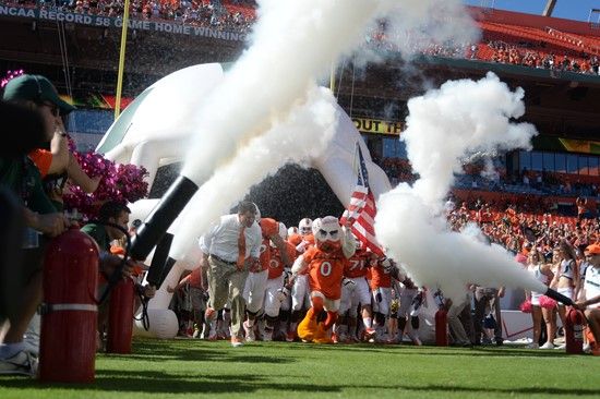 Sebastian the Ibis leads the University of Miami Hurricanes through a tunnel of smoke in a game against the Georgia Tech Yellow Jackets at Sun Life...