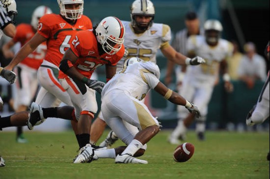 University of Miami Hurricanes running back Derron Thomas #21 tries to recover a fumble in a game against the University of Central Florida Knights at...