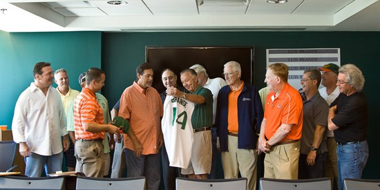 Head baseball coach Jim Morris and Director of Athletics Blake James present Luis Brande with a jersey and cap in recognition of his accomplishments.