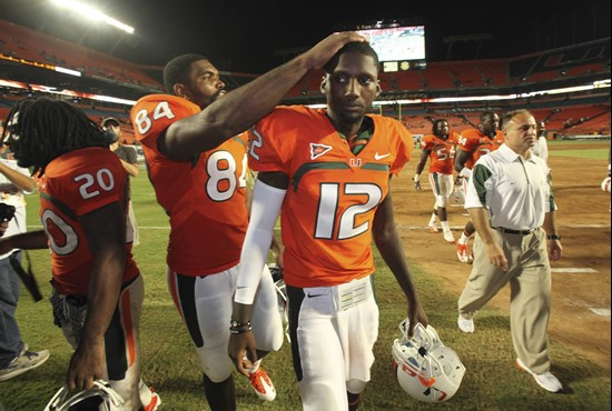 Miami tight end Richard Gordon (84) rubs the head of quarterback Jacory Harris after Miami defeated Florida A&M 45-0 in an NCAA college football...