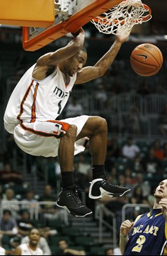 Miami's Lance Hurdle, left, dunks over North Carolina A&T's Glenn Nelson during second half college basketball action at the Bank United Center in...