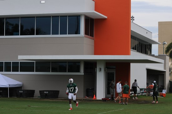 Players run onto the practice field from their new locker room inside the Schwartz Center for Athletic Excellence