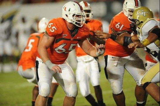 University of Miami Hurricanes offensive lineman Matt Pipho #65 gets set to block in a game against the Georgia Tech Yellow Jackets at Land Shark...