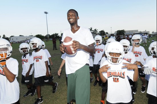 Jacory Harris surrounded by a group of youngsters at PPO Field in Pembroke Pines.