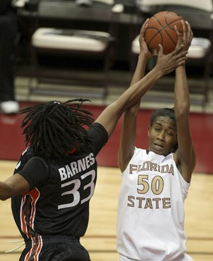 Florida State's Alysha Harvin, right, shoots past Miami's Sylvia Bullock during an NCAA college basketball game Thursday, Feb. 25, 2010, in...