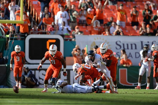 Defensive lineman David Gilbert #11 and The University of Miami Hurricanes plays in a game against the Virginia Cavaliers at Sun Life Stadium on...
