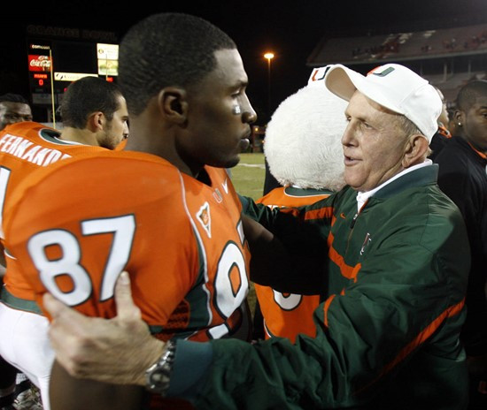 Miami head coach Larry Coker, right, embraces Khalil Jones (87) after Miami defeated Boston College 17-14 Thursday, Nov. 23, 2006, at the Orange Bowl...