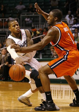 Miami guard Jack McClinton, left, attempts to pass past Virginia forward Will Harris during the first half of basketball Wednesday, Feb. 21, 2007 in...