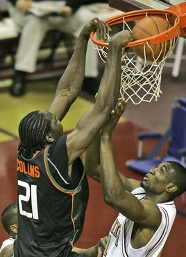 Miami's Dwayne Collins, left, dunks the ball over Florida State's Uche Echefu, right, during the first half of a college basketball game, Saturday,...