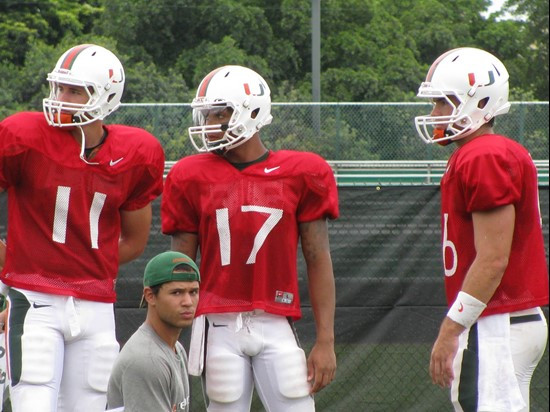 Quarterbacks Ryan Williams, Stephen Morris and Spencer Whipple gather during a practice drill on day six.