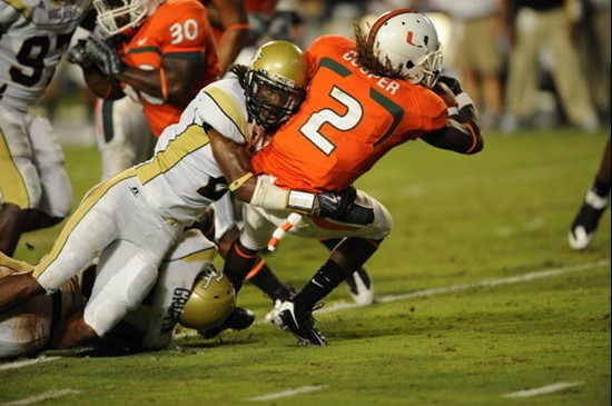 University of Miami running back Graig Cooper #2 fights for extra yards against the Georgia Tech Yellow Jackets at Land Shark Stadium on September 17,...
