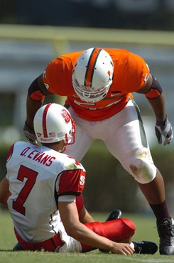 University of Miami defensive tackle McCray, Teraz #54 sacks North Carolina States quarterback Evans (#7) in a game against the Wolfpack at the Orange...